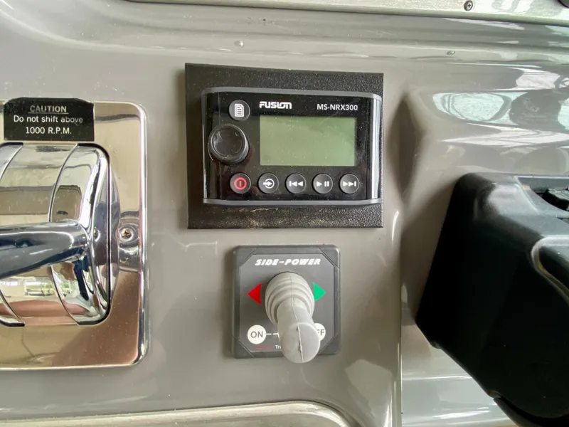 Slide: The Image of Control panel of 2007 Cruisers Yachts 370 Express with Fusion MS-NRX300 and Side-Power controls. - 21