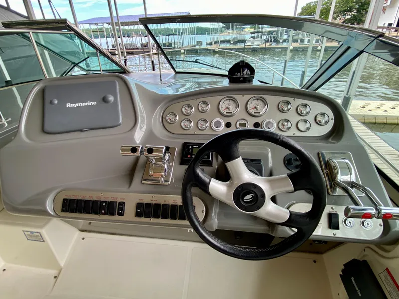 Slide: The Image of 2007 Cruisers Yachts 370 Express helm with steering wheel and control panel. - 23