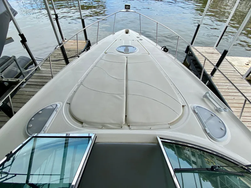 Slide: The Image of 2007 Cruisers Yachts 370 Express boat docked, showcasing spacious deck and sleek design. - 26