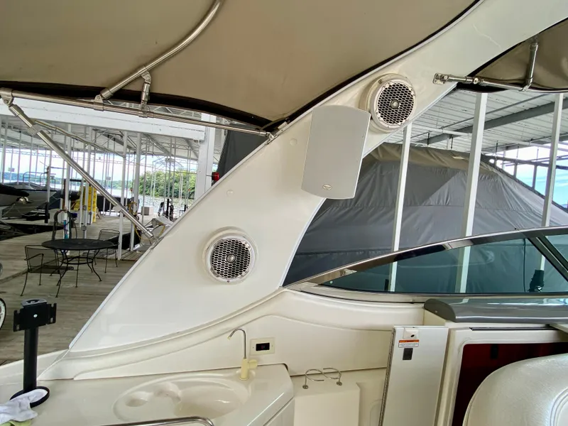 Slide: The Image of 2007 Cruisers Yachts 370 Express interior with speakers and sink in a marina setting. - 30