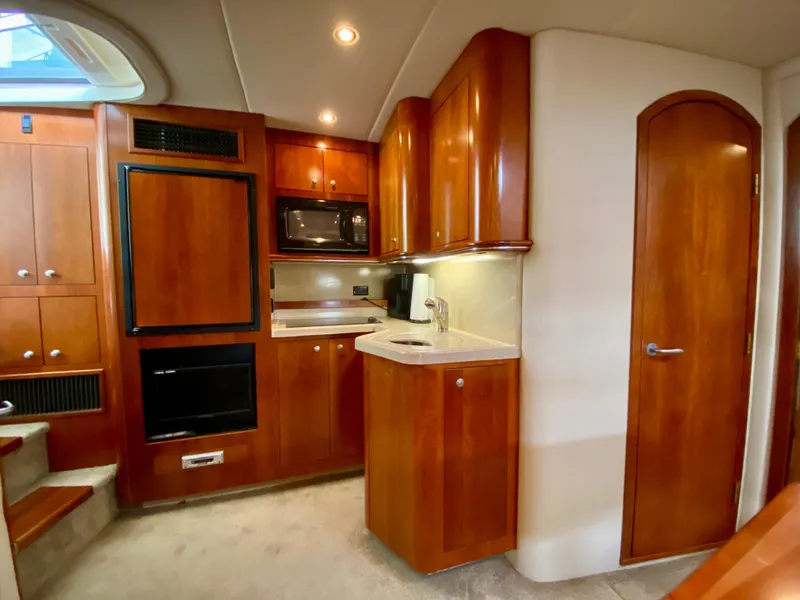 Slide: The Image of 2007 Cruisers Yachts 370 Express interior with wood cabinetry and modern kitchen amenities. - 34