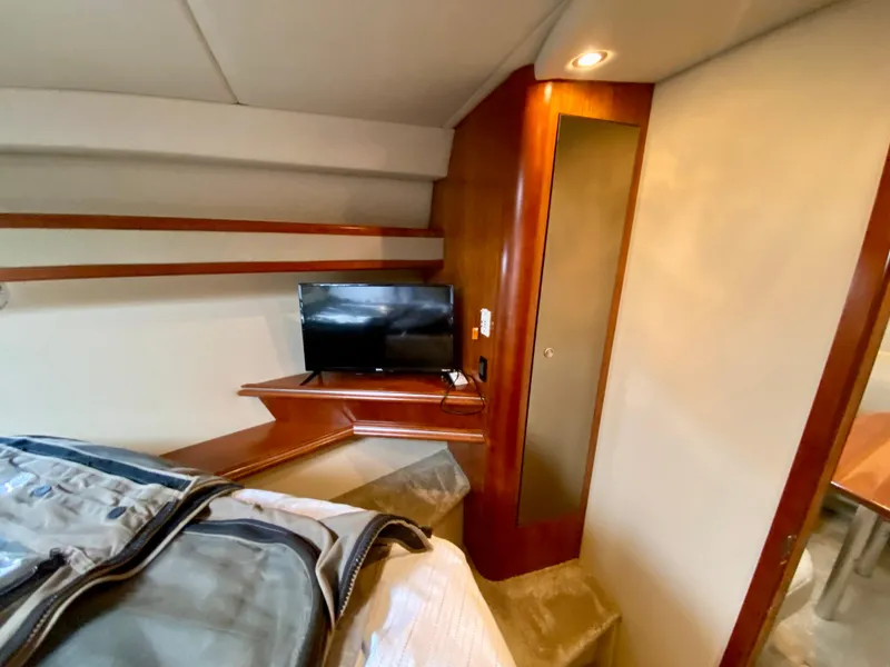 Slide: The Image of 2007 Cruisers Yachts 370 Express cabin interior with TV and wooden cabinetry. - 40