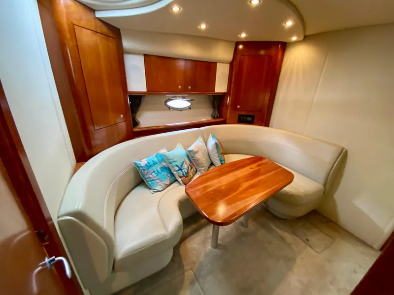 Slide: The Image of 2007 Cruisers Yachts 370 Express interior with curved seating and wooden table. - 41