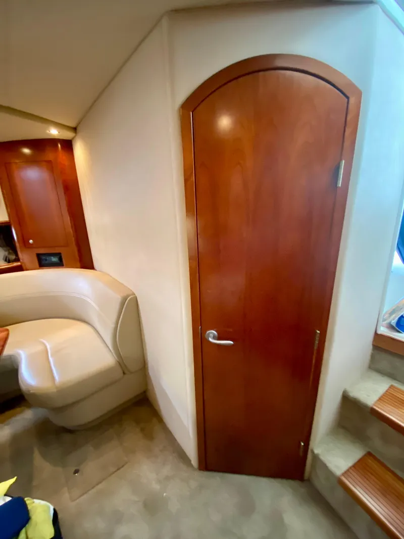 Slide: The Image of Interior of 2007 Cruisers Yachts 370 Express with wooden door and beige seating. - 45