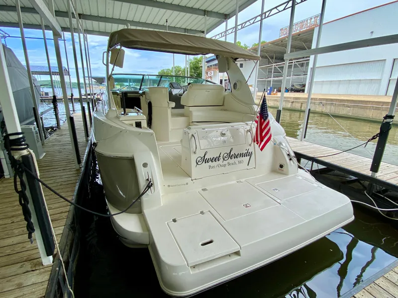 Slide: The Image of 2007 Cruisers Yachts 370 Express docked, featuring "Sweet Serenity" name and American flag. - 6