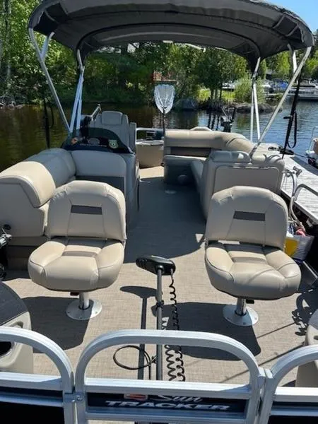 Slide: The Image of 2021 Sun Tracker FB 20 DLX pontoon boat with beige seating and canopy on a sunny day. - 11