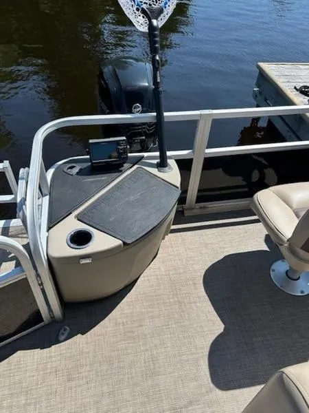 Slide: The Image of 2021 Sun Tracker FB 20 DLX pontoon boat interior with fishing gear and seating. - 14