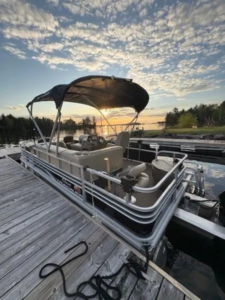 Slide: The Image of 2021 Sun Tracker FB 20 DLX pontoon boat docked at sunset, scenic lake view. - 6