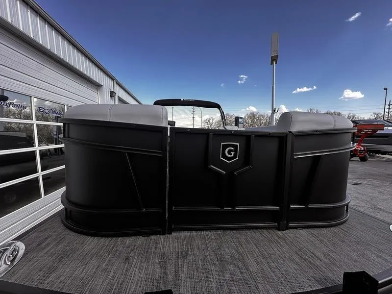 Slide: The Image of 2025 Godfrey Monaco 255 SB iMPACT pontoon boat, black exterior, parked outdoors. - 12