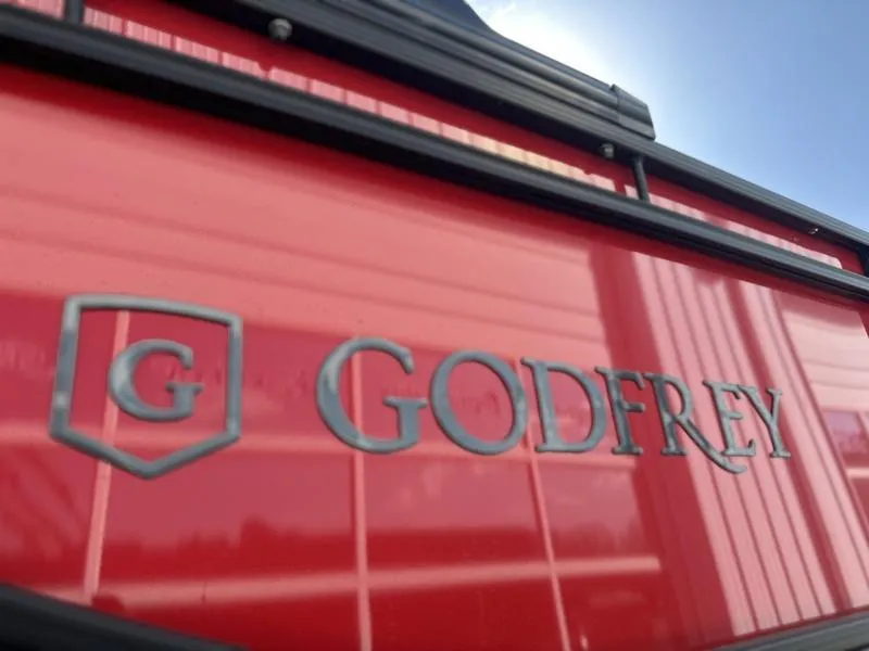 Slide: The Image of Close-up of 2025 Godfrey Monaco 255 SB iMPACT Package logo on red surface. - 14