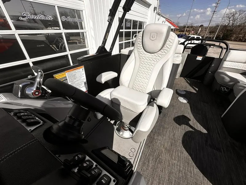 Slide: The Image of Luxurious helm seat on 2025 Godfrey Monaco 255 SB iMPACT pontoon boat, featuring modern controls. - 19