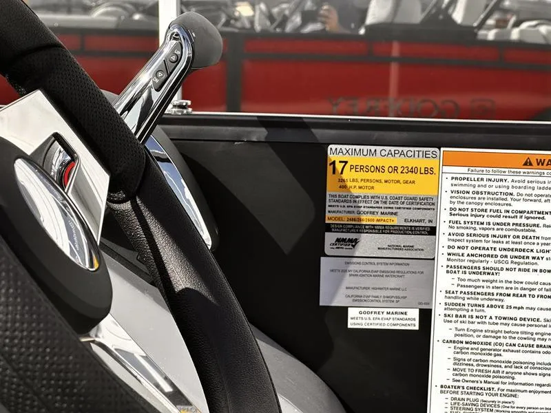 Slide: The Image of Control panel of 2025 Godfrey Monaco 255 SB iMPACT boat, showing capacity and safety warnings. - 2