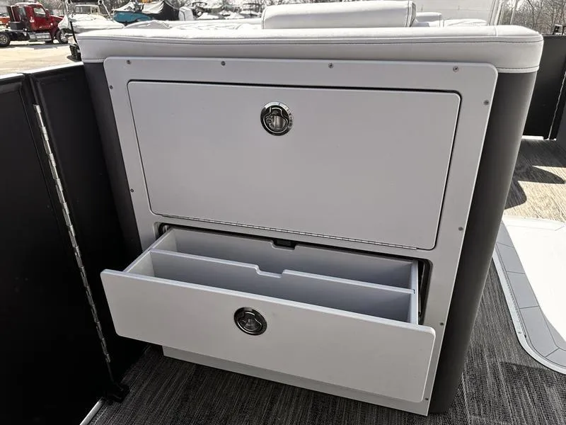 Slide: The Image of 2025 Godfrey Monaco 255 SB iMPACT boat storage compartment with open drawer. - 23