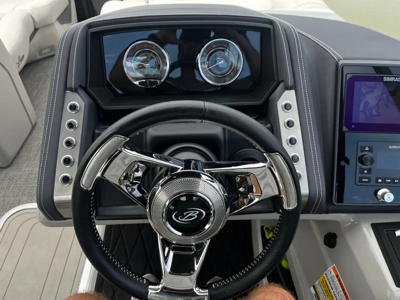 Slide: The Image of 2024 Barletta Lusso 23UC boat dashboard with steering wheel and control panel. - 13
