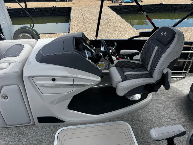 Slide: The Image of 2024 Barletta Lusso 23UC boat interior with luxurious captain's chair and sleek dashboard design. - 26