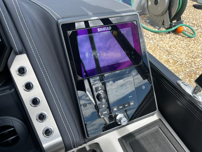 Slide: The Image of 2024 Barletta Lusso 23UC dashboard with Simrad display and control panel. - 28