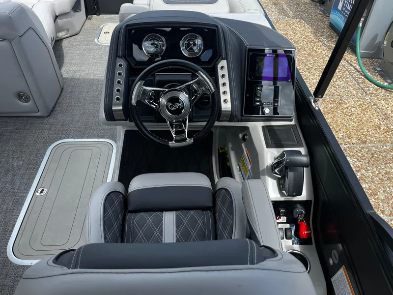 Slide: The Image of 2024 Barletta Lusso 23UC boat cockpit with modern steering wheel and control panel. - 30