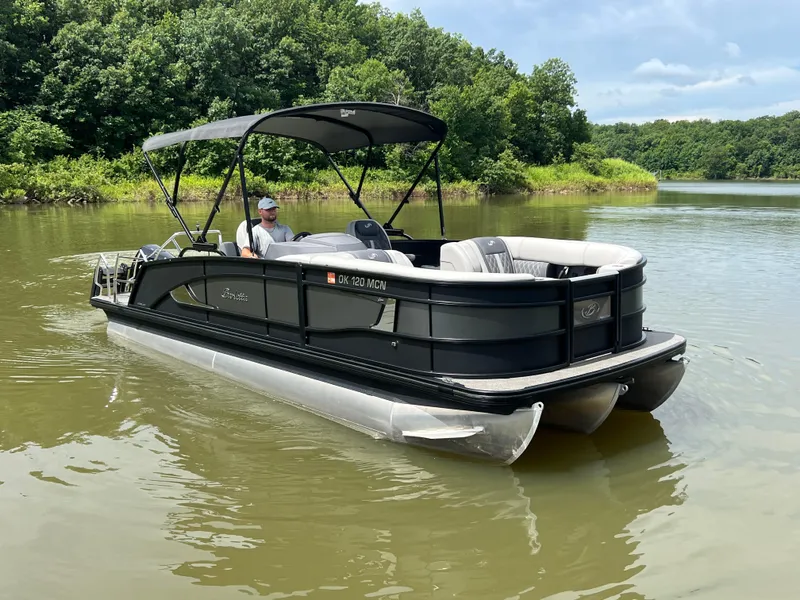 Slide: The Image of 2024 Barletta Lusso 23UC pontoon boat cruising on a serene lake. - 5