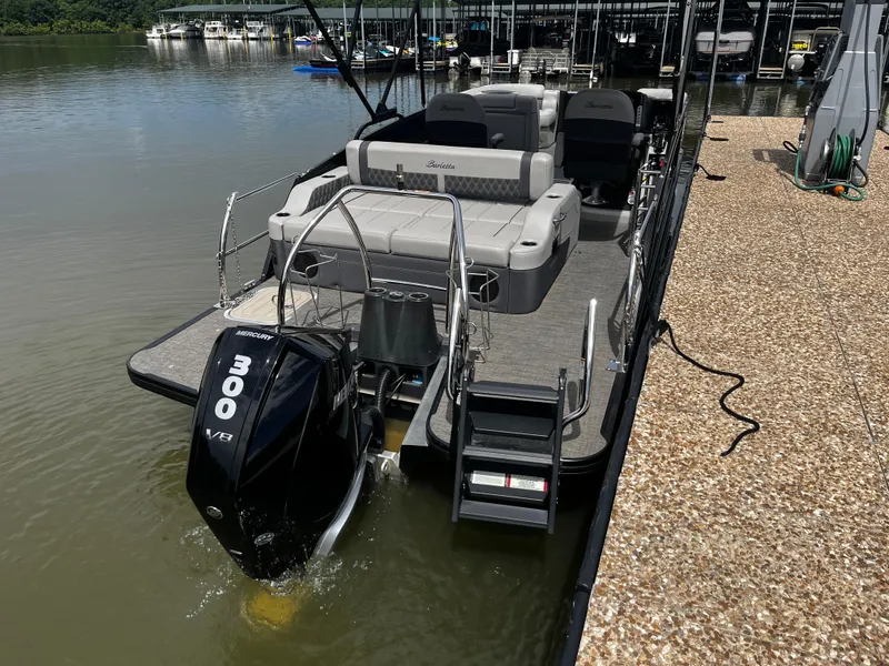 Slide: The Image of 2024 Barletta Lusso 23UC pontoon boat docked, featuring a powerful Mercury 300 V8 engine. - 8