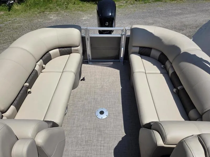 Slide: The Image of 2025 Sun Tracker PARTY BARGE® 22 DLX interior with beige seating and spacious layout. - 13