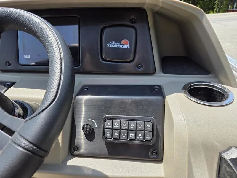 Slide: The Image of 2025 Sun Tracker PARTY BARGE® 22 DLX dashboard with steering wheel and control panel. - 14