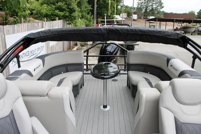Slide: The Image of Luxurious interior of 2025 Starcraft SLS 3 pontoon boat with plush seating and table. - 8