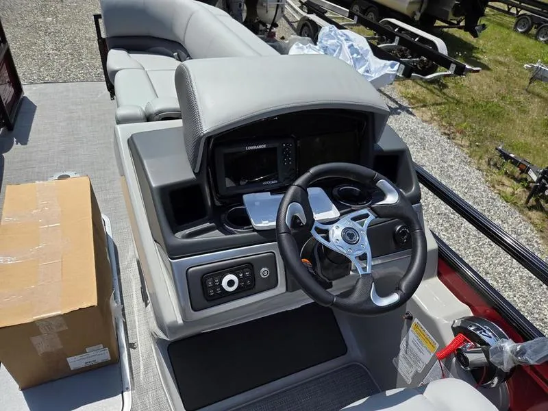 Slide: The Image of 2025 Regency 230 DL3 boat dashboard with steering wheel and control panel. - 11