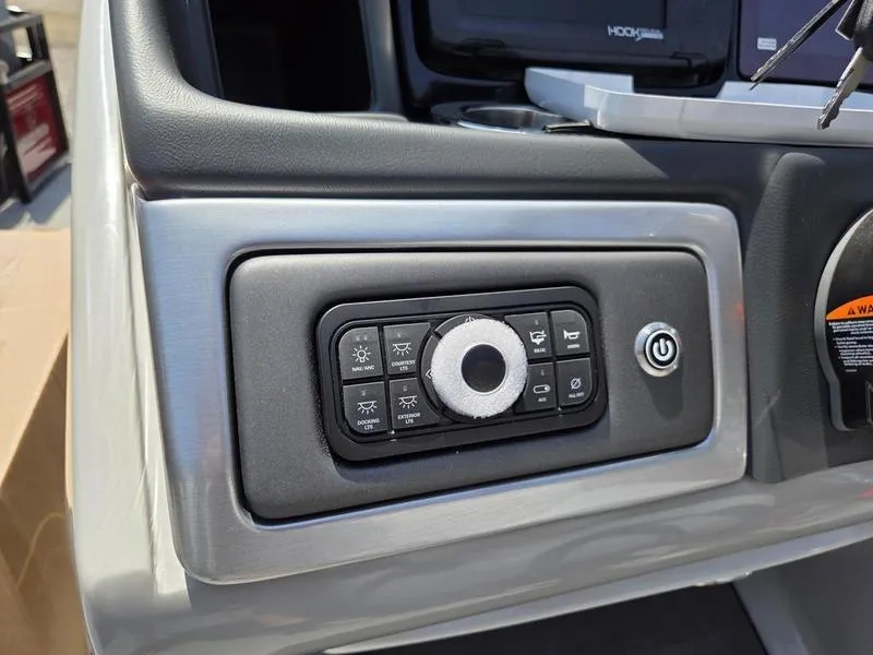 Slide: The Image of Control panel of 2025 Regency 230 DL3 boat with various buttons and power switch. - 16