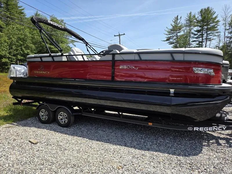 Slide: The Image of 2025 Regency 230 DL3 pontoon boat on trailer, red and black design, parked outdoors. - 6