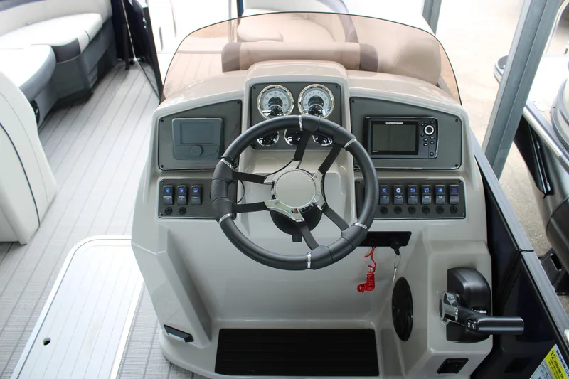 Slide: The Image of 2025 Starcraft EXS 3 DL boat dashboard with steering wheel and control panel. - 10