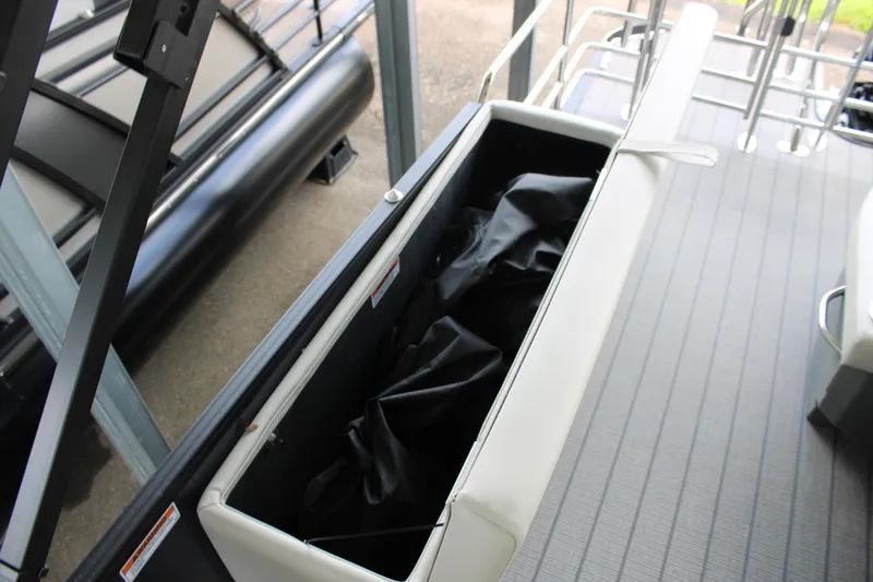 Slide: The Image of Open storage compartment on 2025 Starcraft EXS 3 DL boat, showcasing interior space. - 14