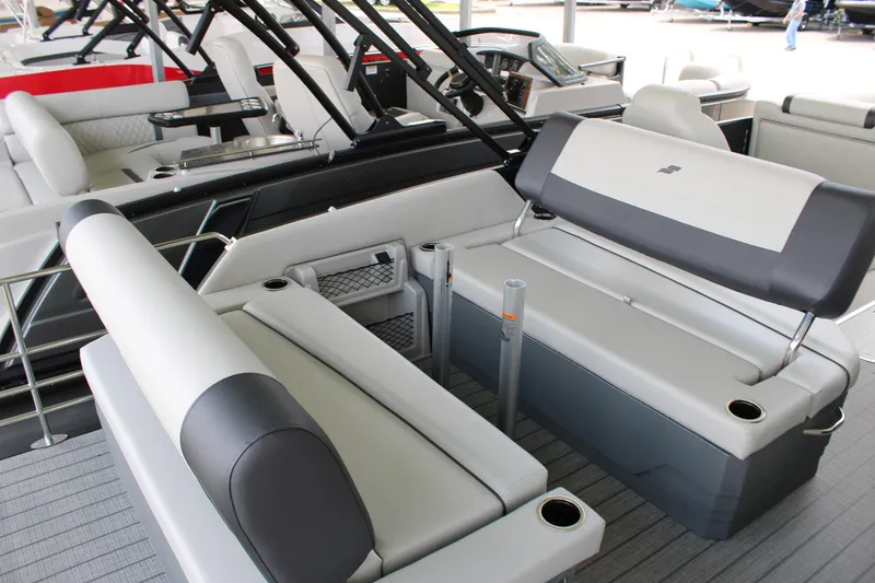 Slide: The Image of 2025 Starcraft EXS 3 DL boat interior with gray seating and cup holders. - 17