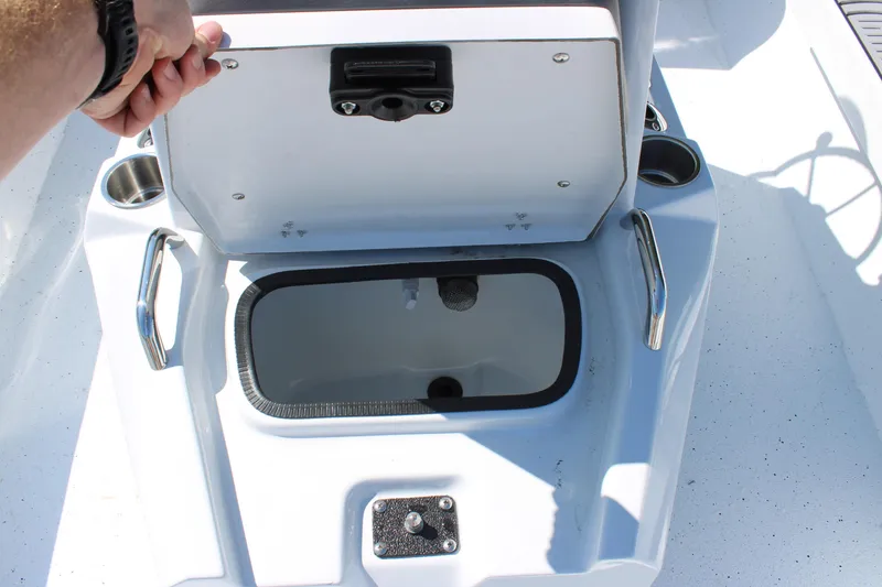 Slide: The Image of Open storage compartment on 2026 Xpress H22B Bay boat deck. - 13