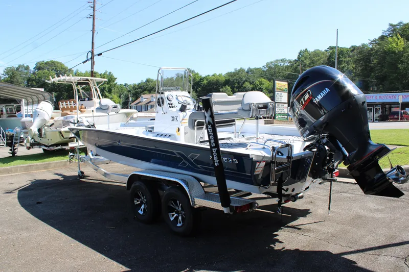 Slide: The Image of 2026 Xpress H22B Bay boat with Yamaha engine on a trailer in a parking lot. - 3