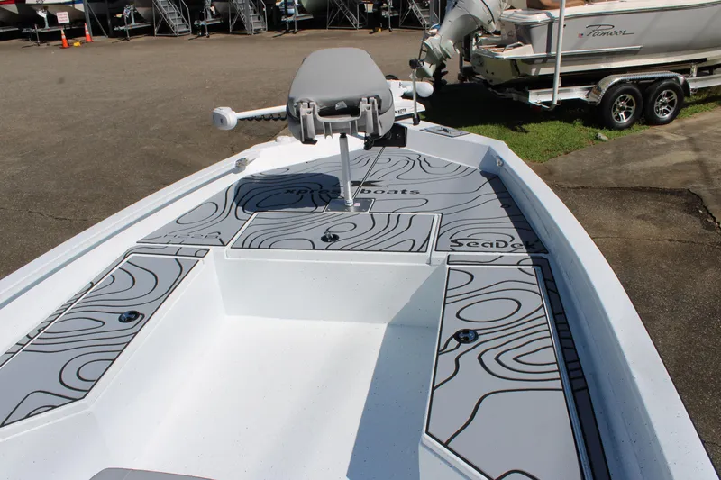 Slide: The Image of 2026 Xpress H22B Bay boat with SeaDek flooring, parked outdoors. - 6