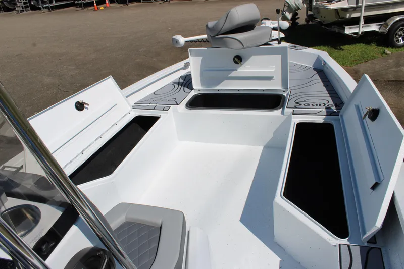 Slide: The Image of 2026 Xpress H22B Bay boat interior with open storage compartments and seating. - 7