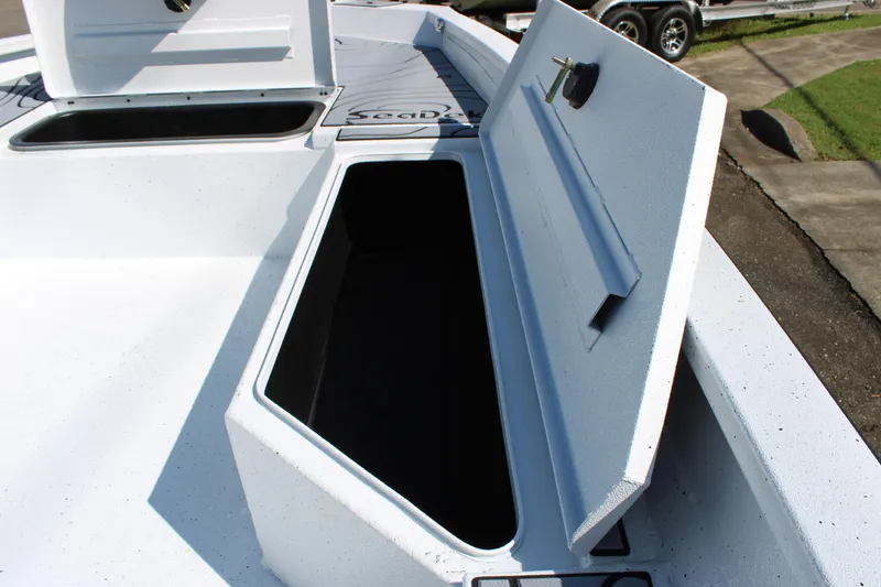 Slide: The Image of Open storage compartment on 2026 Xpress H22B Bay boat deck. - 8