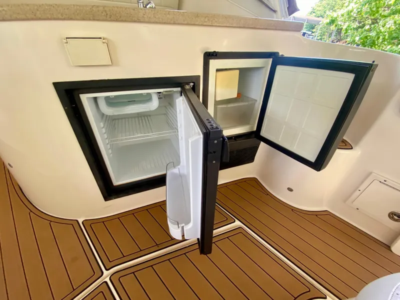 Slide: The Image of Open fridge on 2006 Rinker 360 Fiesta Vee boat with teak flooring. - 13
