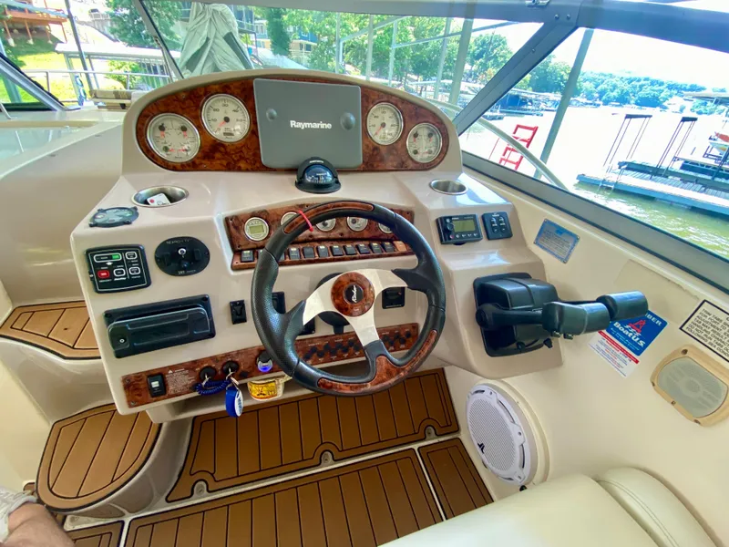 Slide: The Image of 2006 Rinker 360 Fiesta Vee boat dashboard with steering wheel and navigation controls. - 15
