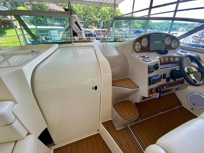 Slide: The Image of 2006 Rinker 360 Fiesta Vee boat cockpit with modern controls and wood accents. - 20