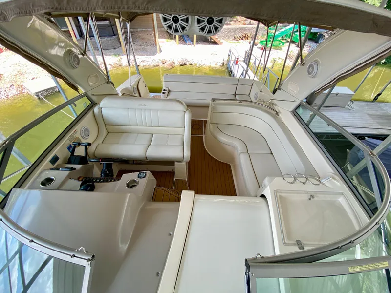 Slide: The Image of 2006 Rinker 360 Fiesta Vee boat interior with white seating and helm station. - 21