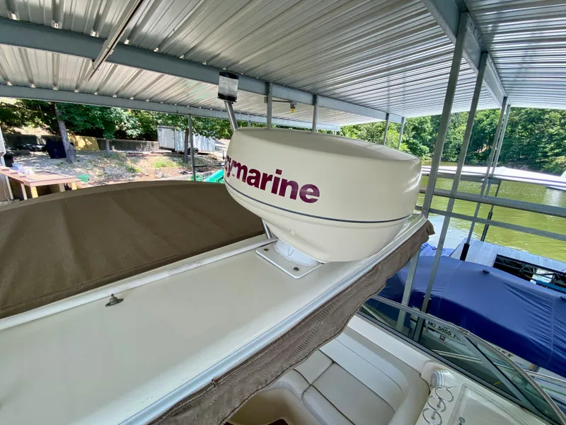 Slide: The Image of 2006 Rinker 360 Fiesta Vee boat with radar, docked under a metal canopy. - 23