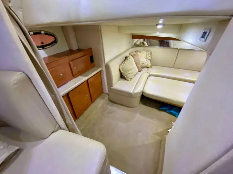 Slide: The Image of Interior of 2006 Rinker 360 Fiesta Vee yacht with beige seating and wooden cabinets. - 33