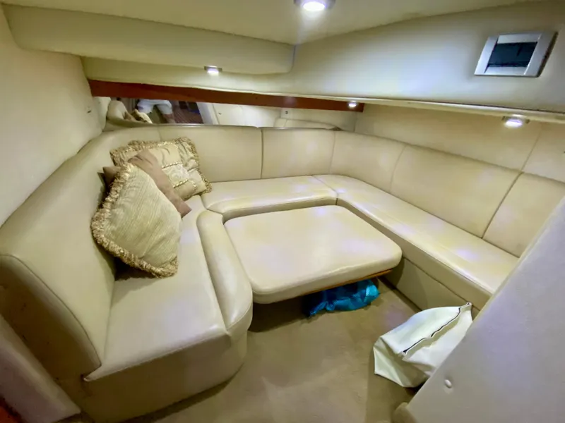 Slide: The Image of 2006 Rinker 360 Fiesta Vee cabin interior with beige seating and cushions. - 34