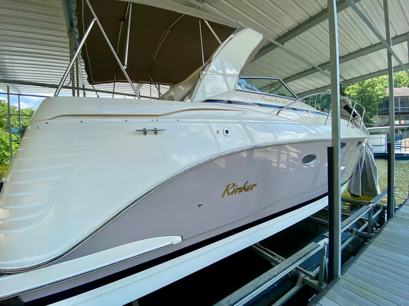 Slide: The Image of 2006 Rinker 360 Fiesta Vee boat docked under a covered marina. - 4