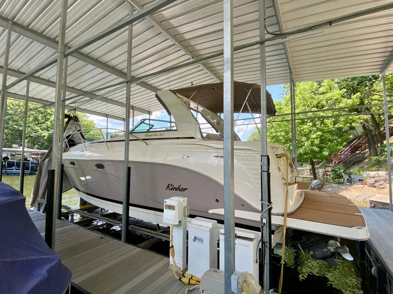 Slide: The Image of 2006 Rinker 360 Fiesta Vee boat docked under a covered marina. - 6