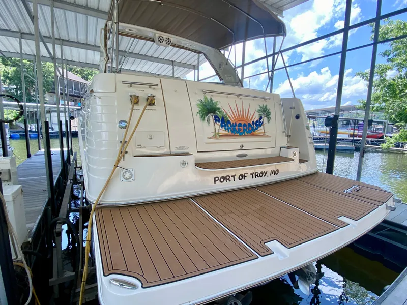 Slide: The Image of 2006 Rinker 360 Fiesta Vee docked, featuring teak swim platform and "Port of Troy, MO" inscription. - 7