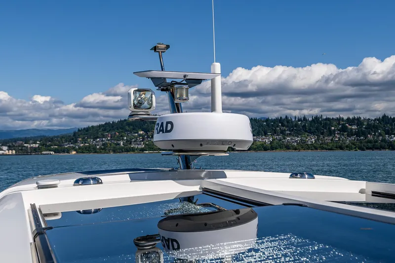 Slide: The Image of Nimbus 405 Coupé #88, 2021 model, cruising on a lake with scenic forested hills. - 12