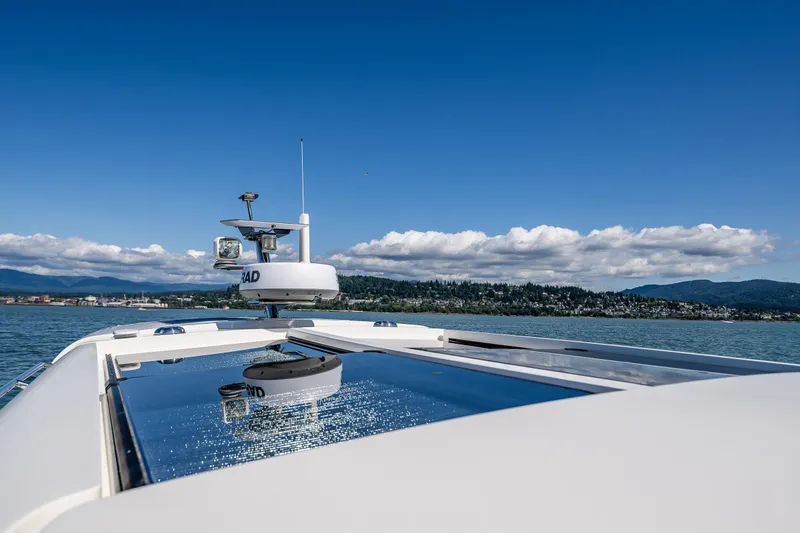 Slide: The Image of Nimbus 405 Coupé #88, 2021 model, cruising on a serene lake with scenic mountain backdrop. - 13