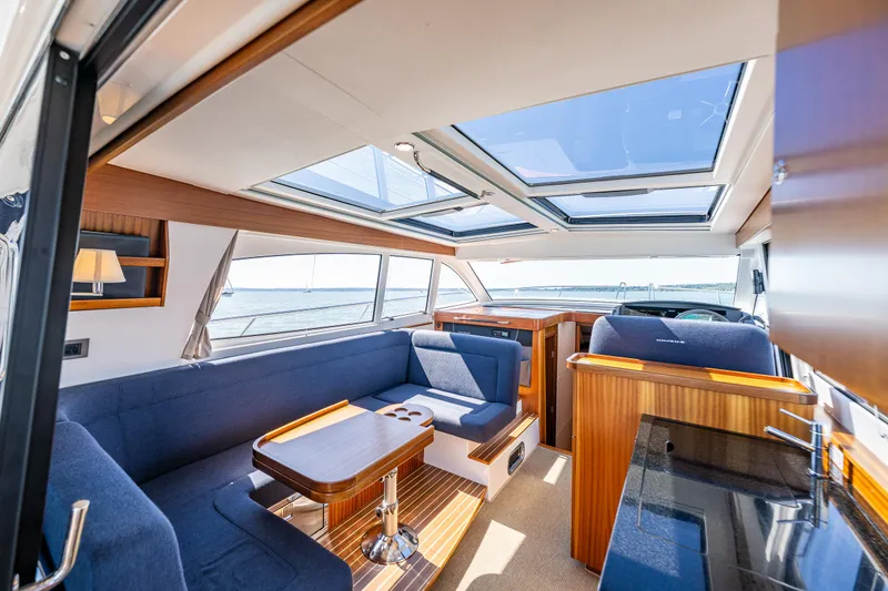 Slide: The Image of Luxurious interior of 2021 Nimbus 405 Coupé yacht with skylights and elegant seating. - 15